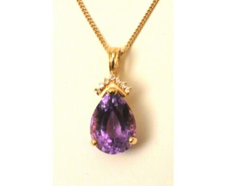 A 14ct  gold amethyst and diamond pendant, the large pear shaped 12ct amethyst, set with seven brilliant cut mili diamonds ab