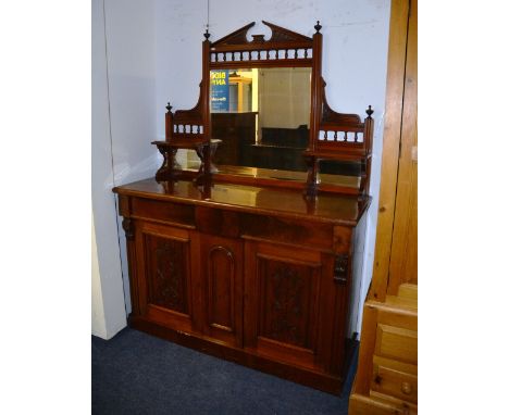 A late Victorian mahogany mirror back sideboard, the mirrored top having broken pediment above plate glass mirror, flanked by