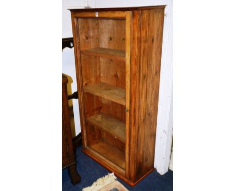 A glazed bookcase, enclosing shelves, 140cm high x 74cm wide, together with an oak gun wall hanging shelf, 142cm high, a conv