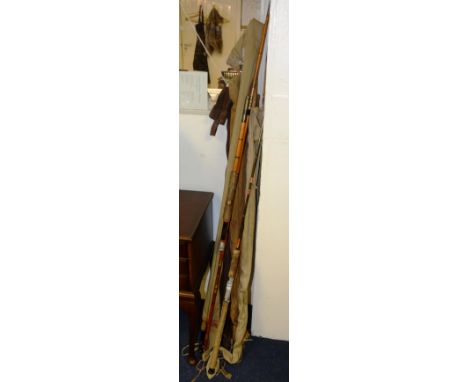 A quantity of vintage split cane fishing rods, some with canvas covers