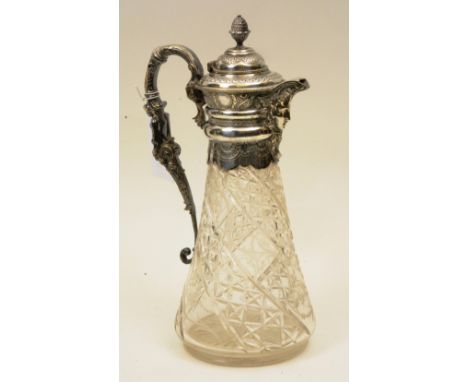 A silver plated collared claret jug, with domed lid mounted by pineapple finials, mask spout, scrolling mermaid handle, over 