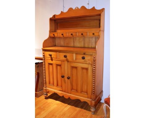 A Victorian Scotch pine dresser, with shelved gallery back above fitted drawers, above further fitted drawers and two panelle