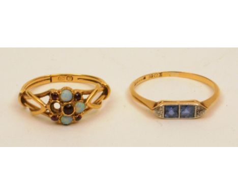 An 18ct gold sapphire and diamond ring, the two central square cut sapphires flanked by two mili diamonds to either side, rin