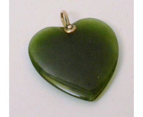 A yellow metal and jade style heart shaped pendant, (without chain), 4cm long