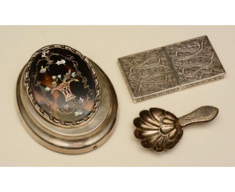 A white metal card case, with allover foliate decoration, including a silver caddie spoon, Sheffield 1910 by Thomas Bradbury 