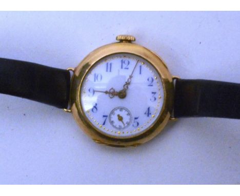 An 18 carat gold cased wristwatch , the circular dial with blue enamel Arabic numerals and fancy gold hands, with subsidiary 
