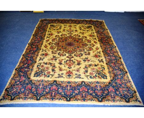 A Persian Kirman carpet, the central floral medallion over yellow ground with floral design and border, 333 x 251cm