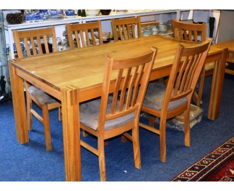 A modern light oak dining table, 75cm high x 180cm long x 90cm wide, together with six similar bar back dining chairs (7)