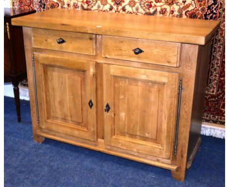 A modern light oak kitchen cupboard, with two short drawers above two panelled doors, 90cm high x 120cm wide x 49cm deep