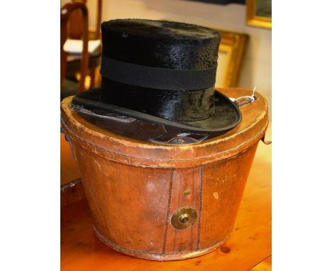 A vintage black top hat, with tan leather carry case, 31cm diameter CONDITION REPORT: Lot 324 - Inside measurements: 16cm wid