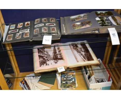 A vintage postcard album, together with a vintage photograph album, mostly Italian related, a cigarette card album and other 