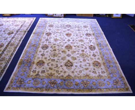 A silk Sarook Kashan carpet, with allover foliate design on beige ground with triple light blue border, 342 x 234cm