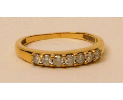 A yellow metal seven stone diamond ring, with seven graduated brilliant cut diamonds set along straight of shaft, approx. 0.2