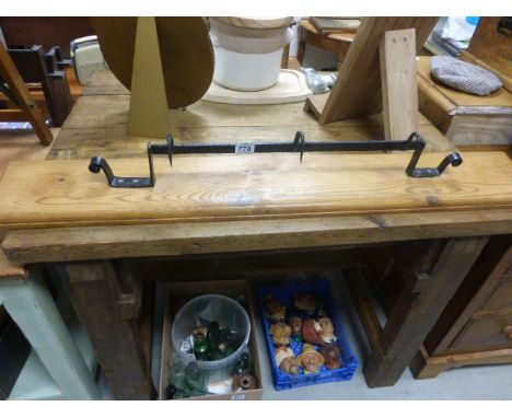 A pine wall hanging shelf with wrought iron game hooks