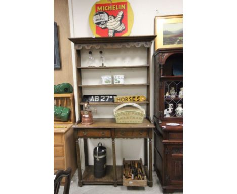 Oak dresser with open shelves above two drawers and pot shelf below