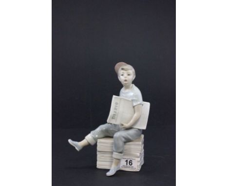 A Nao figure of a seated boy