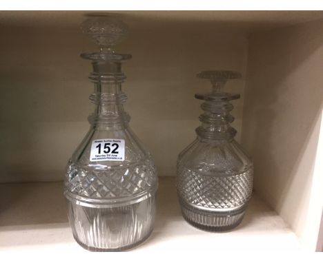 An early 19th century glass decanter and stopper with triple ring neck, along with a 19th century decanter with cut glass mid