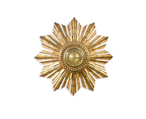 A mid-century carved giltwood sunburst clock, the gilded dial with Arabic numerals and set within radiating faceted rays40cm 