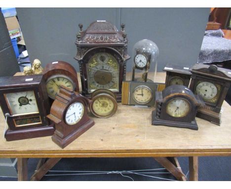 A 19th century carved mantle clock; together with various other wooden mantle clocks, and a skeleton clock