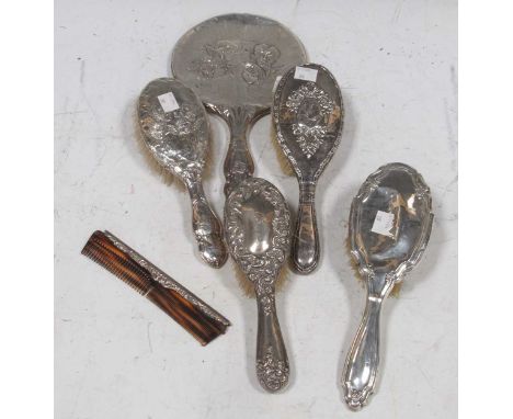 A collection of four silver hairbrushes, together with hand mirror and comb