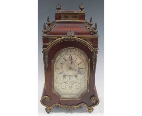 A Victorian mahogany and gilt metal mounted mantel clock, with arched silvered dial and gong striking French movement