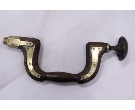 A VINTAGE WOOD AND BRASS BRACE
