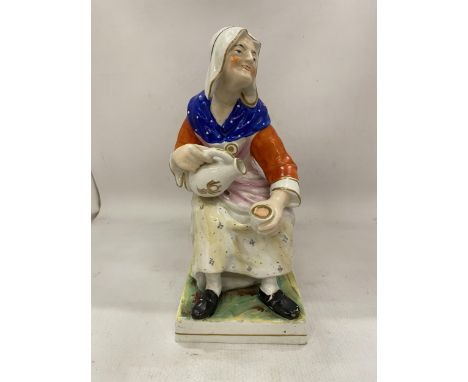 A LARGE VINTAGE STAFFORDSHIRE FIGURE "NELL THE COBBLERS WIFE" WITH A CAT HIDING UNDER THE CHAIR