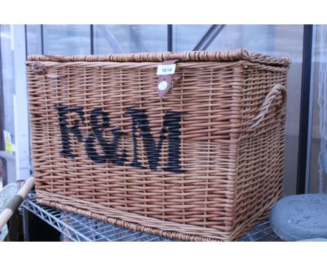 A FORTNUM AND MASON HAMPER BASKET WITH SIDE HANDLES AND LEATHER STRAPS