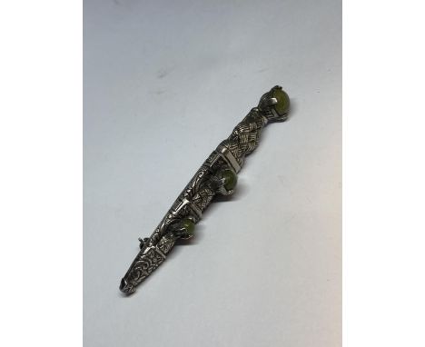 A MIRACLE KILT PIN WITH THREE JADE COLOURED STONES