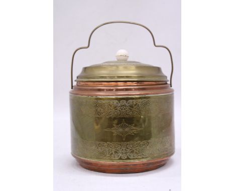 A VINTAGE BRASS AND COPPER BISCUIT BARREL