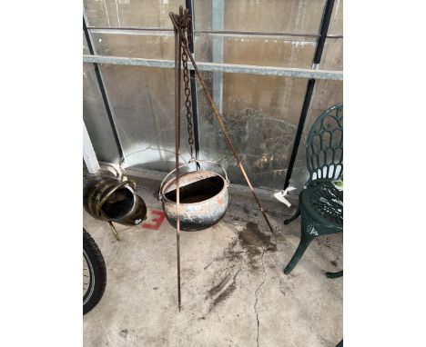 A VINTAGE CAST IRON COOKING POT ON A TRIPOD
