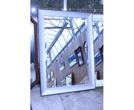 A SILVER COLOURED BEVEL EDGE WALL MIRROR, 34.5" X 24.5"