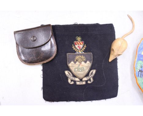 A VINTAGE MANCHESTER UNIVERSITY BADGE, CARVED MOUSE AND LEATHER POUCH