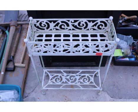 A DECORATIVE METAL PLANT STAND WITH LOWER SHELF