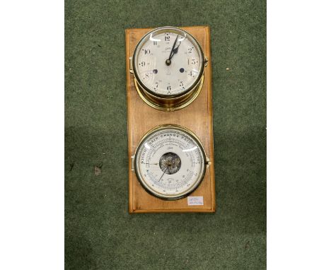 A VINTAGE SCHATZ BRASS ROYAL MARINER SHIP CLOCK AND BAROMETER ON A WOODEN STAND
