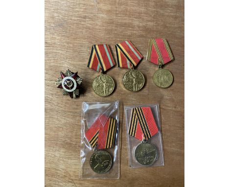 A COLLECTION OF FIVE RUSSIAN MEDALS AND AN ENAMEL BADGE