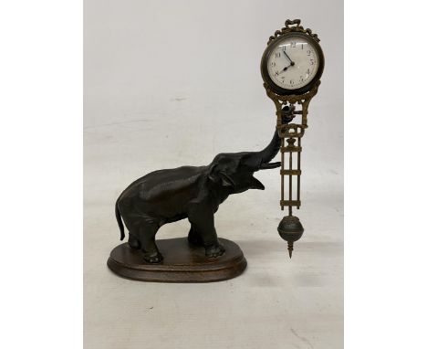 AN ANTIQUE ELEPHANT MYSTERY CLOCK BELIEVED TO BE JUNGHANS GERMANY WITH A DECORATIVE GRIDIRON PENDULUM