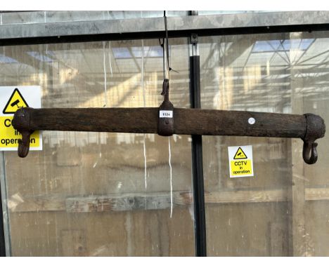 A VINTAGE WOODEN YOKE WITH METAL HOOKS