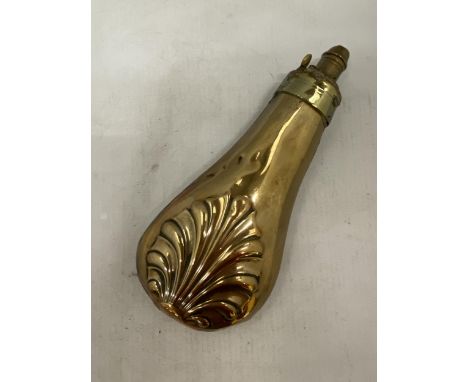 A 19TH CENTURY COPPER POWDER FLASK WITH BOTH SIDES EMBOSSED WITH A SHELL WITH BRASS CHARGER