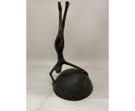 A VINTAGE CAST IRON PAL-BELL DANCER SCULPTURE