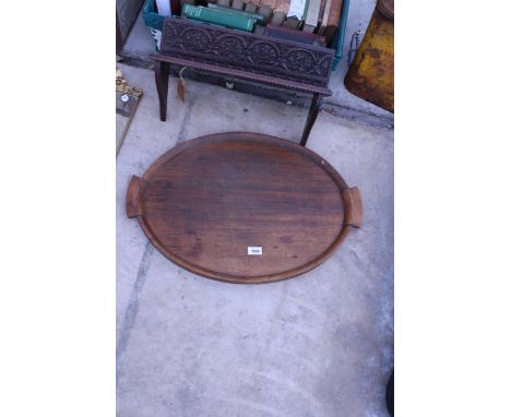 AN OVAL OAK TWIN HANDLED TRAY AND A CARVED SHELF