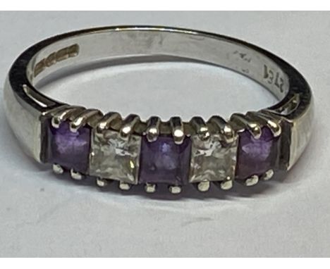 A 9 CARAT WHITE GOLD RING WITH FIVE IN LINE STONES THREE AMETHYST AND TWO CUBIC ZIRCONIA SIZE L