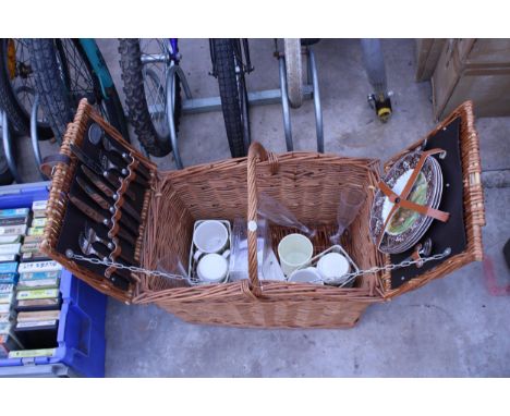 A WICKER PICNIC HAMPER BASKET AND CONTENTS