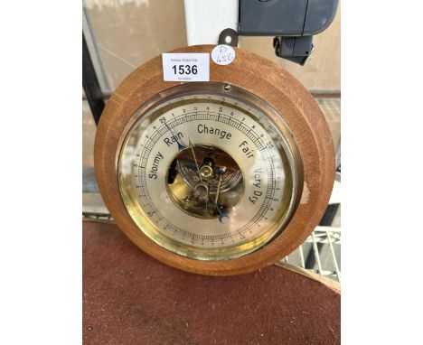 A WOODEN CASED CIRCULAR BAROMETER