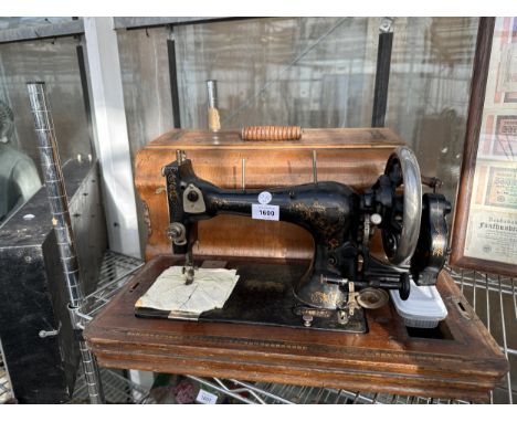 A VINTAGE SEWING SEWING MACHINE WITH A CASE