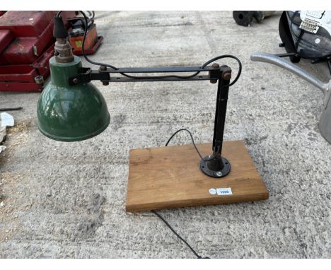 AN INDUSTRIAL STYLE LAMP WITH GREEN ENAMEL SHADE ON A WOODEN BASE