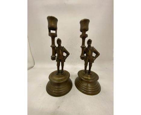 A PAIR OF FRENCH BRASS MEDIEVAL PAW GUARD CANDLESTICK HOLDERS