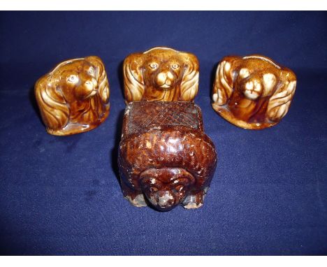 Three 18th/19th C treacle glaze Spaniel head money jars (approx height 8cm) and a brown glazed 18th C sash window stop in the