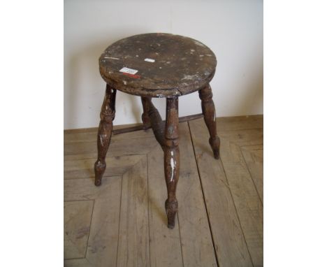 Rustic circular topped stool on turned supports 
