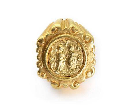 A gold coin ring or tie clip, the coin depicting two men shaking hands, unidentified, mounted in an oval frame to the centre 